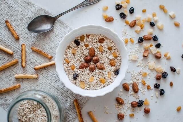 oatmeal in a bowl with spoon and peanuts