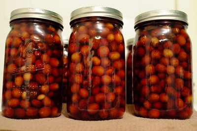 three glass containers of cherries